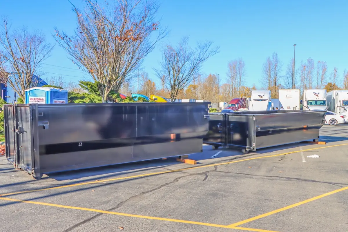 Professional dumpster rental service with roll-off container on residential driveway in Champaign